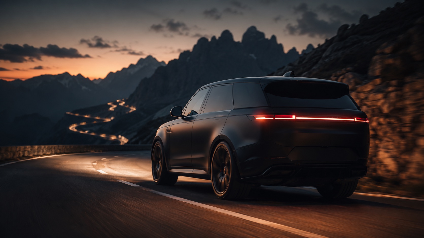 A matte-black Range Rover Sport SV on a mountain pass at dusk.